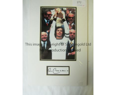 FRANZ BECKENBAUER AUTOGRAPH     A colour 10" X 8" mounted picture of Beckenbauer holding the World Cup trophy aloft and under