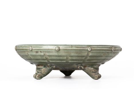 A LARGE CELADON EIGHT TRIGRAMS TRIPOD CENSER
The shallow heavily potted dish raised on three animal mask supports, the exteri