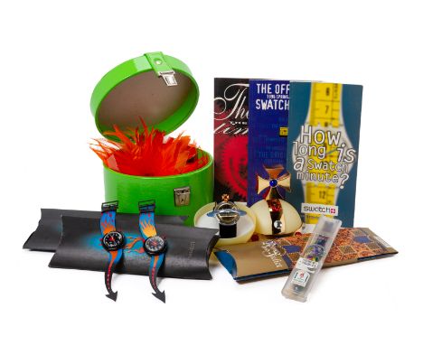 A GROUP OF SWATCH WATCHES AND BOOKLETS Comprising a Vivienne Westwood 1993 Pop Swatch with orb case, an orange 'Feathers' swa