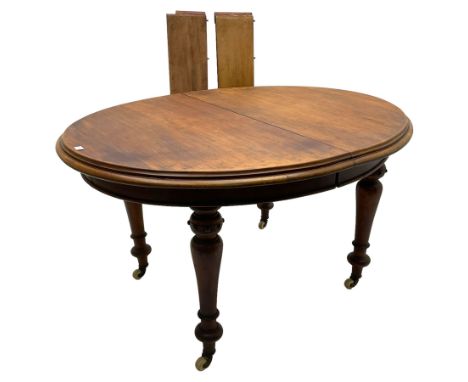 Victorian mahogany oval extending dining table, moulded edge and banded frieze, turned supports on ceramic castors with two a