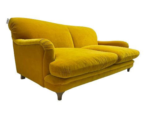 Loaf - large two seat 'Jonesy' sofa, upholstered in mustard velvet fabric with sprung back and loose seat cushions, raised on