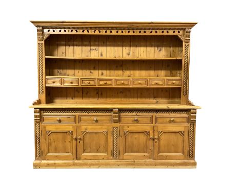 Large traditional pine dresser, projecting reeded cornice over two tier plate rack fitted with eight spice drawers, flanked b