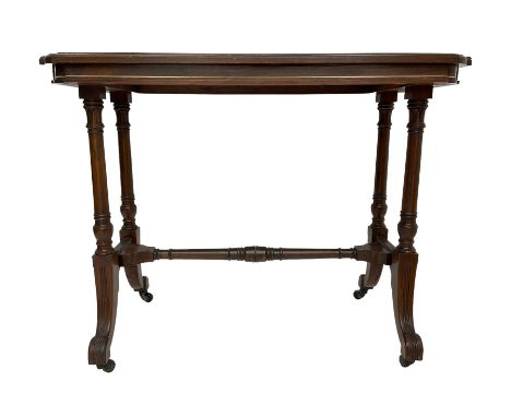 Late Victorian rosewood stretcher table, the rectangular top with curved canted cornice and moulded edge, on quadruple turned