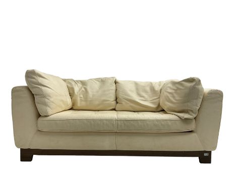 Roche-Bobois - two seat sofa, upholstered in ivory leather with buttoned seat cushions, raised on a stained beech base with b