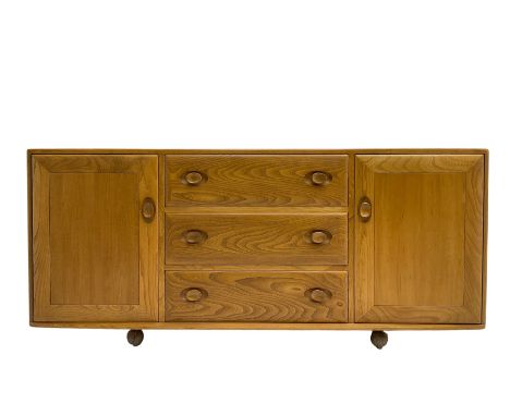 Ercol - mid-20th century blonde elm 'Windsor' sideboard, fitted with three drawers flanked two cupboards, on castorsDimension