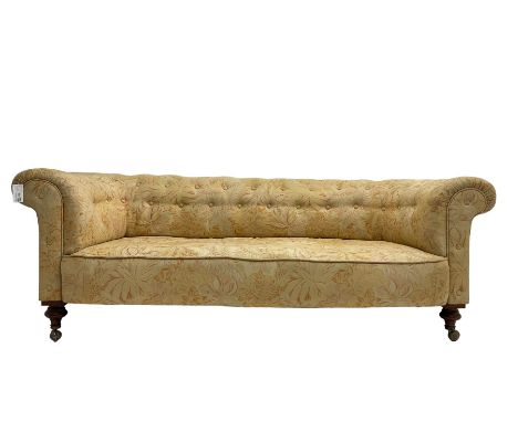 Early 20th century Chesterfield sofa, upholstered in buttoned coral and beige foliate patterned fabric with sprung seat, rais