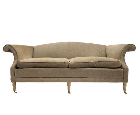 Traditional three seat sofa, curved back over scrolled arms, upholstered in crushed beige fabric with matching loose cushions