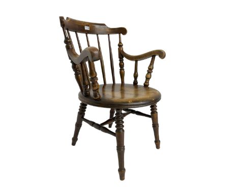 Early 20th century stained beech Captain's chair, comb back with scrolled arm terminals over penny seat, raised on turned sup