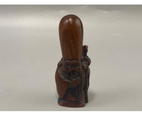 Hand carved Japanese Netsuke in the form of a village elder, signed on base, H6cm
