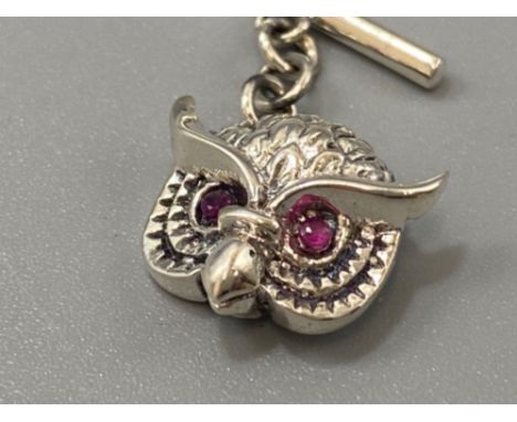 A pair of silver owl-shaped cufflinks with ruby eyes, weight 5.38grams