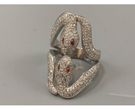 A silver double snake ring set with CZ and ruby eyes, weight 8.44grams