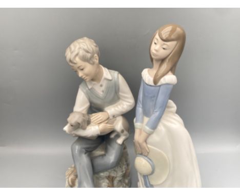 A lot of to Nao Figures to include boy with dog and girl holding a hat