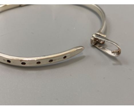 A silver bangle in the form of a belt, weight 15.01grams