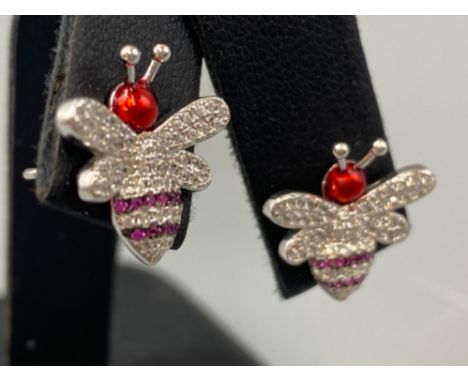 A pair of silver, CZ and ruby banded bug stud earrings, weight 3.21grams