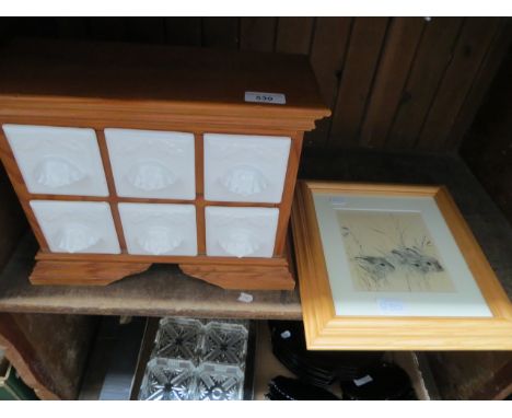 Modern ceramic and wooden spice drawers and a print depicting rabbits. 