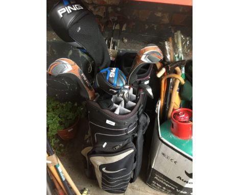 A Nike golf bag with 2 x Ping G30 graphite shafted metal woods, and 2 Ping G10 graphite shafted rescue clubs10, and 2 Taylor 