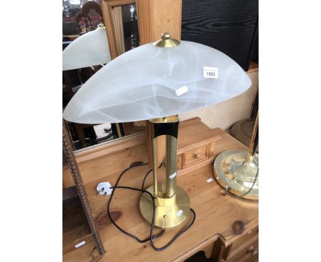 A brass table light with glass shade 