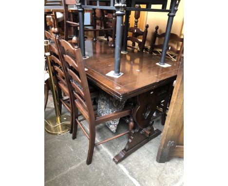 An oak drawer leaf table and six ladder back chairs 