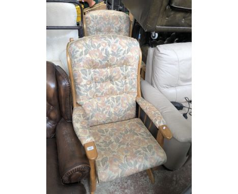 A pair of light wood framed rocking chairs 