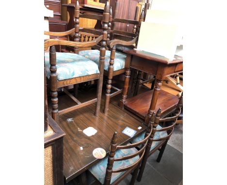 An extending dining table and eight curved ladder back chairs 