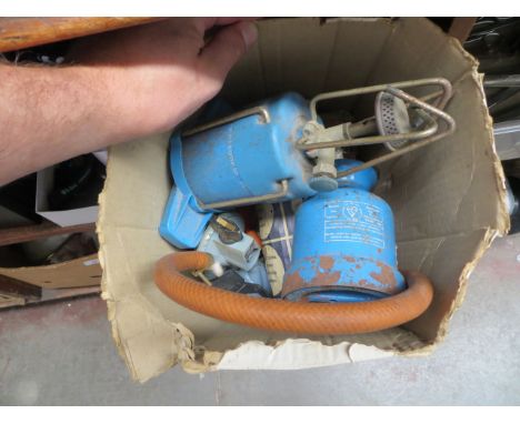 A camping gas stove, a camping gas blow lamp, 9 gas canisters and gas regulator 