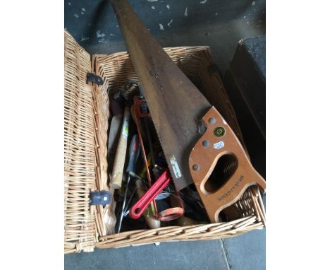 A wicker picnic hamper full of tools 