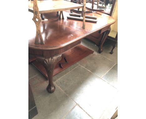 A mahogany wind out table with two additional leaves on cabriole legs with shell detailing, claw and ball feet and ceramic ca