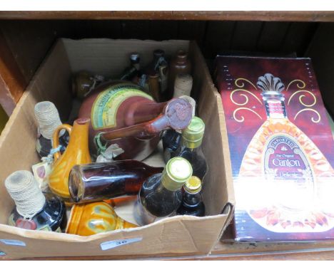 A box with ceramic bottles some full, European bottles with Polish honey wine and other wines, empty Canton ginger liquor bot