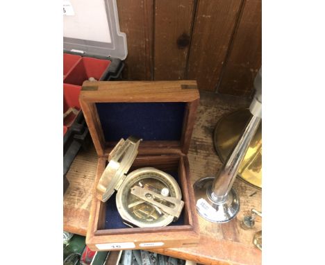 A boxed brass compass