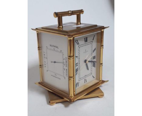 A Looping gilt brass revolving carriage clock with thermometer, barometer and hygrometer 