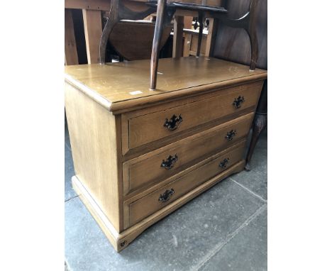 A light oak reproduction chest of drawers 