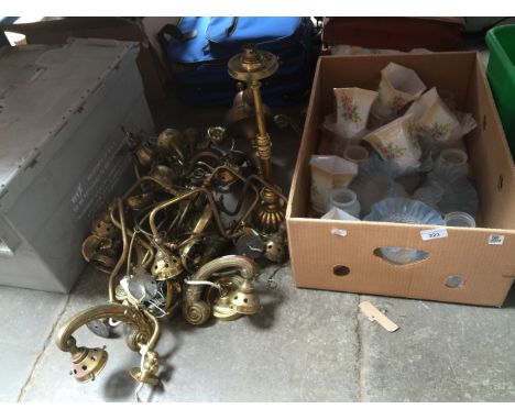 A box of glass light shades and four bags of light fittings including brass and wall sconces 