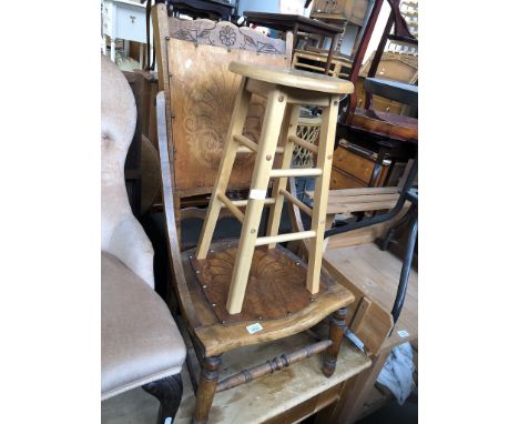 A low American style chair and a light wood stool 