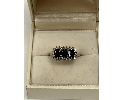 A 9ct sapphire and diamond ring, 2.6g gross. Size K.