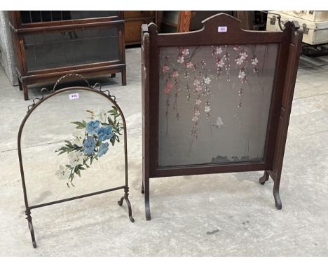 An early 20th Century oak firescreen with embroidered silk banner, 37" high; together with a painted glass example.