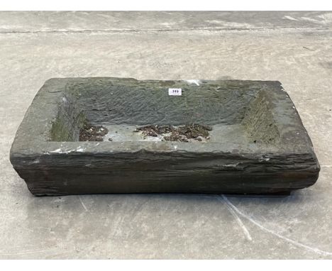 A Welsh slate trough of roughly hewn form. 28" x 18". Hole to base.