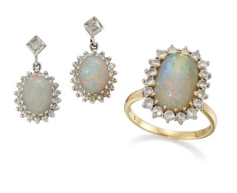 An 18ct gold opal and diamond cluster ring, the cabochon opal to surround of brilliant-cut diamonds, all claw set to a plain 