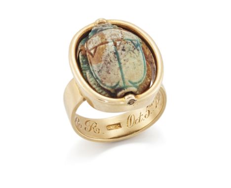 An early 20th century gold scarab ring, the Egyptian composite scarab bead in swivel mount, to plain broad hoop, engraved wit