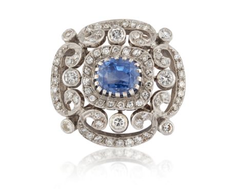 A sapphire and diamond cluster brooch, the central claw-set cushion-cut sapphire with single-cut diamond border, brilliant-cu