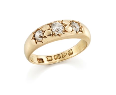 An Edwardian 18ct gold three stone diamond ring, with a row of graduated old European-cut and Swiss cut diamonds, star set to