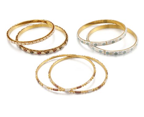 Six Indian enamelled bangles, one pair with blue floral design to a white enamel ground; one pair with red and white banded e