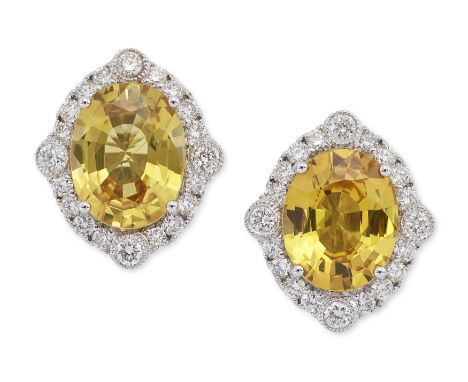 A pair of yellow sapphire and diamond earrings,&nbsp;of cluster design, with an oval mixed cut yellow sapphire to surround of