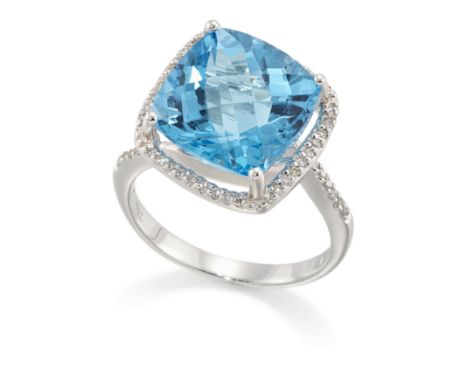 A blue topaz and diamond ring, the cushion shaped chequer cut blue topaz, approximately 11.7mm, claw set to halo of grain-set