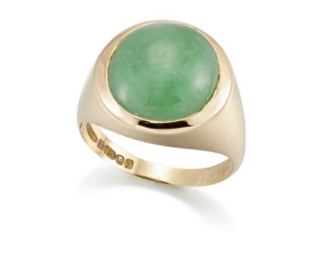 An 18ct gold single stone jadeite jade ring,&nbsp;the oval jadeite jade cabochon, rubover set, to tapered shoulders and a pla