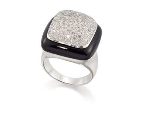 A diamond and onyx ring, the domed, cushion shaped head pavé set with brilliant-cut diamonds, to a carved onyx bezel, taperin