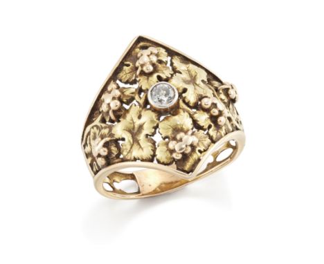 A 20th century two colour gold diamond ring, the pierced lozenge shaped head of grape and vine design, rubover set to the cen