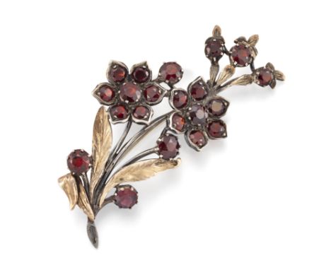Sybil Dunlop. A silver and garnet brooch, of floral spray design, set with round mixed cut garnets, London hallmarks, 1968, m