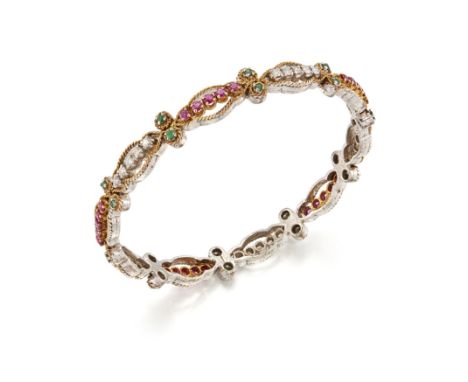 A diamond, ruby and emerald bangle, with sets of brilliant-cut diamonds and round mixed cut rubies, with pairs of round mixed