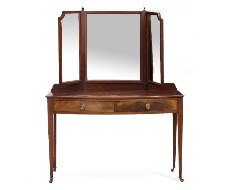 AN EDWARDIAN MAHOGANY BOW FRONTED DRESSING TABLE with a three sectional mirror above two short drawers and square tapering le