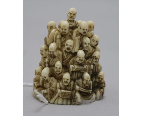 A Japanese ivory netsuke of multiple rakan, Meiji period, the underside carved as clouds inset with a black lacquer seal engr